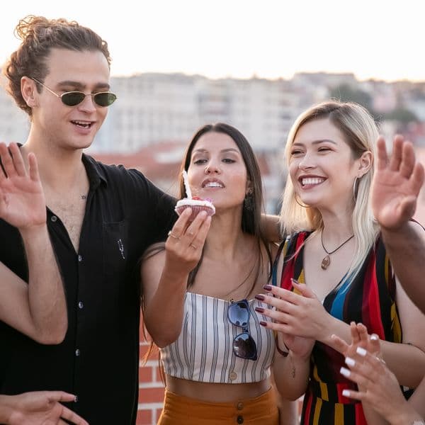 Friends sharing a cupcake at golden hour