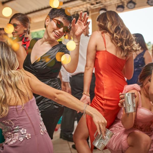 Guests dancing together under string lights