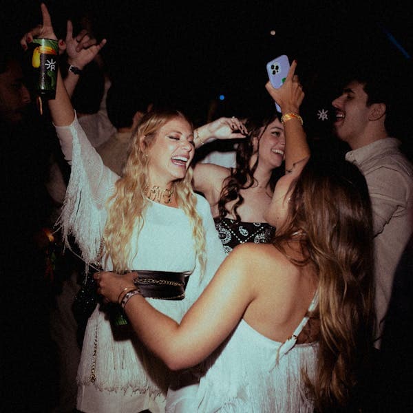 Guests taking a phone selfie on the dance floor
